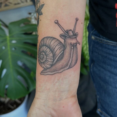 The most rootinest tootinest snail 

@brittanomyces 

#snail #snailtattoo #cowbo… — tattoo by Chelsea  Dagger, Orange, California