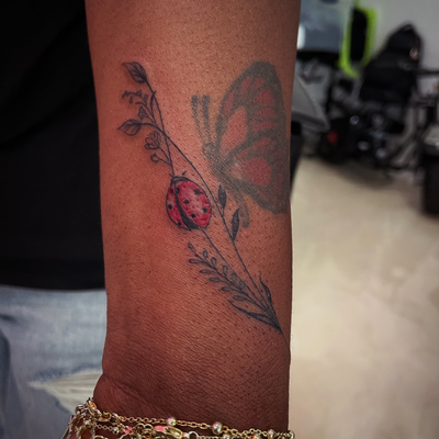 Cute ladybug & lil flowers…
Not the butterfly — tattoo by Jc TheArtist, Downey, California