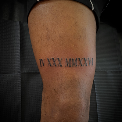 Roman numerals with the I on the corners completely solid in — tattoo by Jc TheArtist, Downey, California