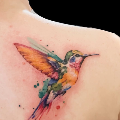 color humming bird — tattoo by Marc Douglas, Fullerton, CA