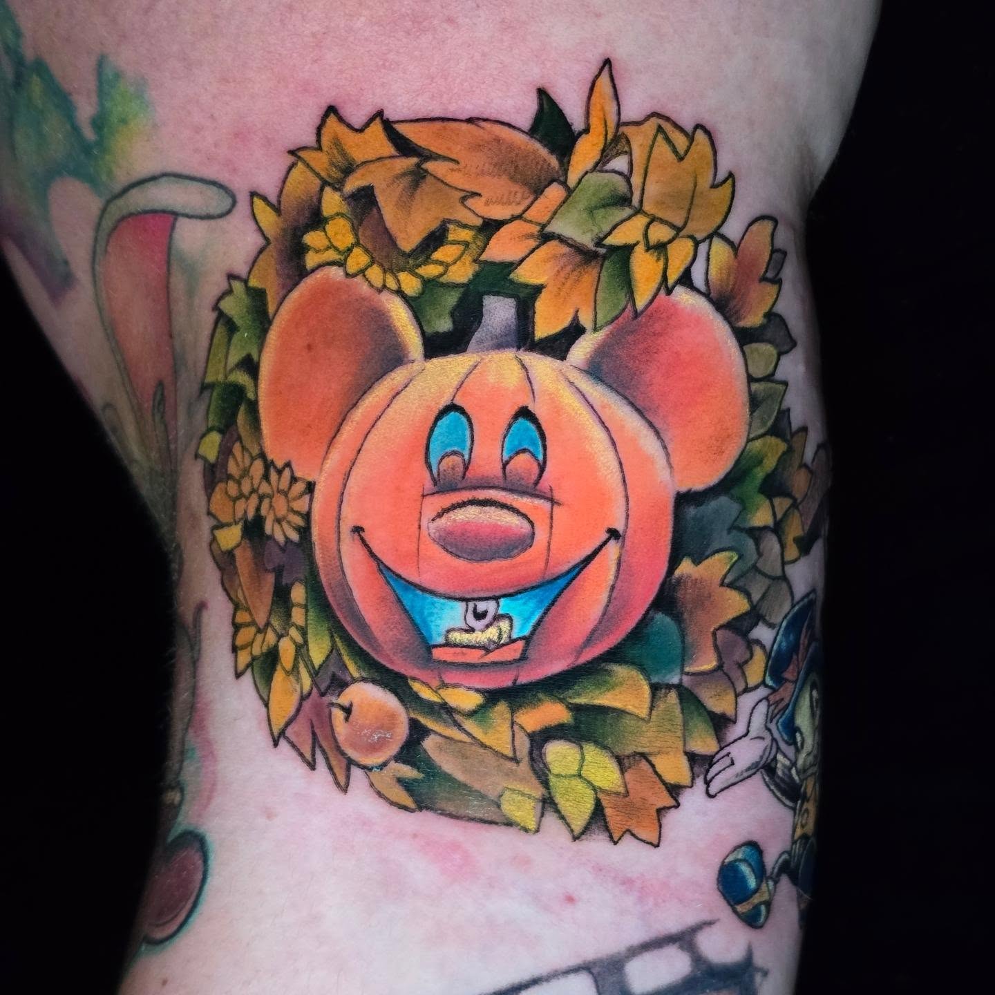Mickey's not so scary tattoo mash up.
Mouse 'OLantern wreath, lit up by the blac… — tattoo by Barbie Lavon, Troy, Michigan