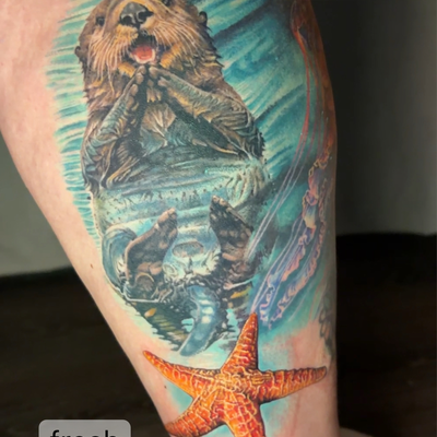 Color realism sea otter in the ocean getting his swim on alongside a starfish. — tattoo by Irina Shapiro, Somerville, Massachusetts