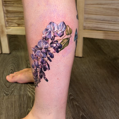 Color realism wisteria wrapping around the leg. — tattoo by Irina Shapiro, Somerville, Massachusetts