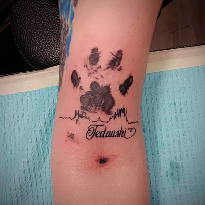 #pawprints #pawprintstattoo #blackandgreytattoo — tattoo by Jim  Lyons, Portsmouth, Rhode Island