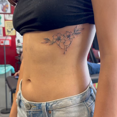 Delicate floral work with just enough ornamental detail to complement the placem… — tattoo by Jessica Hurteau, Newport Beach, California