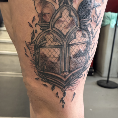 Recent black & gray gothic inspired piece featuring cathedral windows, mountains… — tattoo by Jessica Hurteau, Newport Beach, California