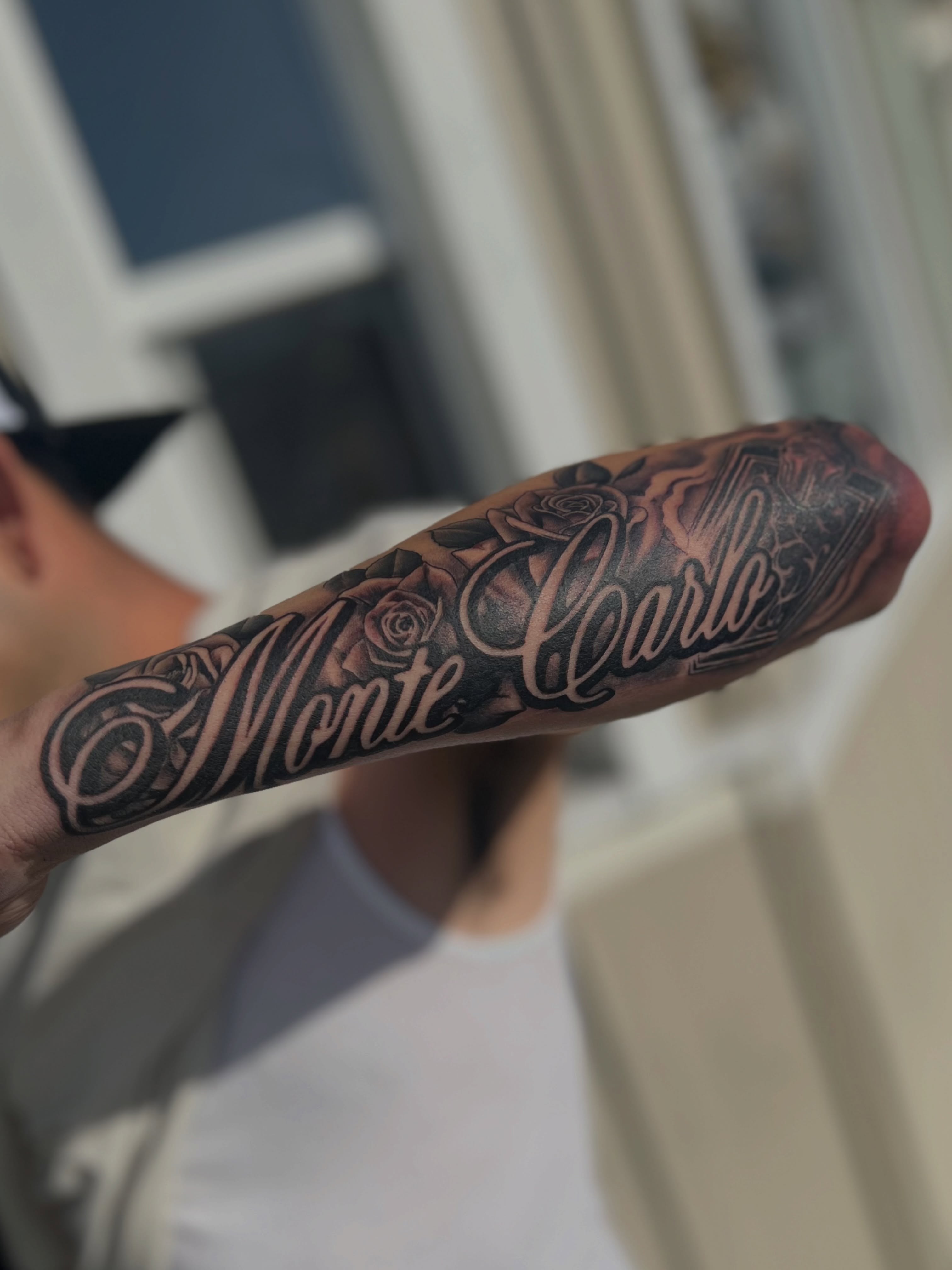 Monte Carlo/emblem/roses. He wanted this tattoo specifically place so when he re… — tattoo by Quan G, Union City, California