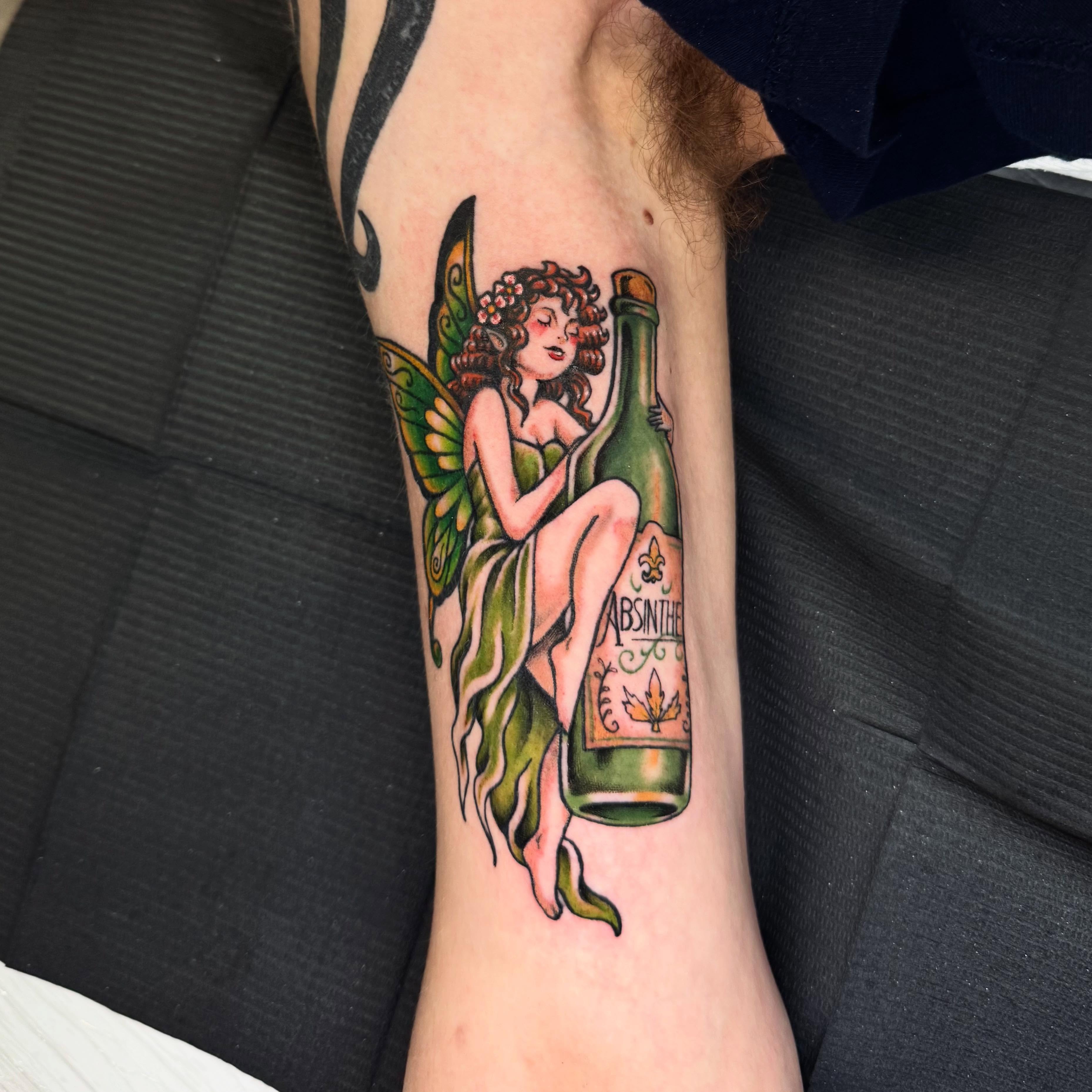 I had so much fun designing this custom green absinthe fairy for my man Odin 🧚 … — tattoo by Aiden Busiel, Chicago, Illinois