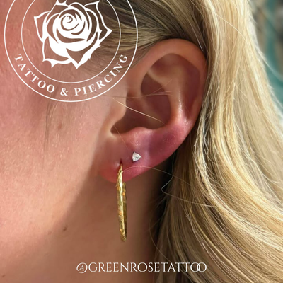 Pair of second lobe piercings by @stephensteelstudios with beautiful Trillion Cu… — tattoo by Stephen Marion, Holyoke, Massachusetts