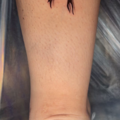 laces bow tattoo — tattoo by RedTip Tattoos, Springfield, Massachusetts