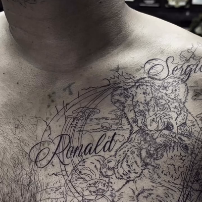 Chest tattoo featuring two small lions, representing his two children 🦁🦁. The … — tattoo by Fredy Amaya, Chelsea, Massachusetts