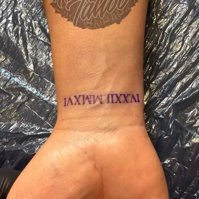 Wedding anniversary day Tattoo in Roman numeral — tattoo by Ricky Aragon, Elkhorn, Nebraska